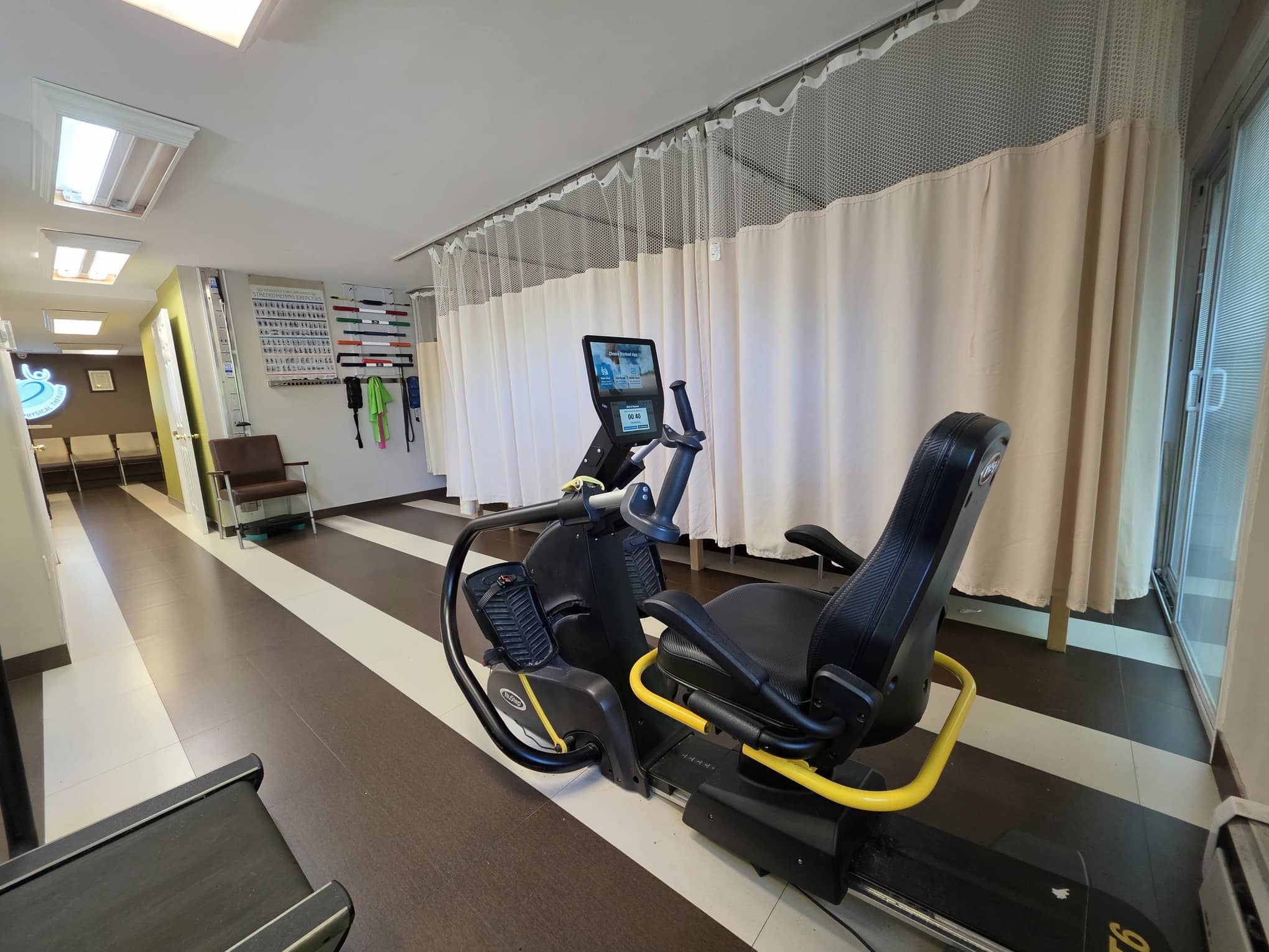 Glen Oaks gym floor with rehabilitation cycle and treatment bays