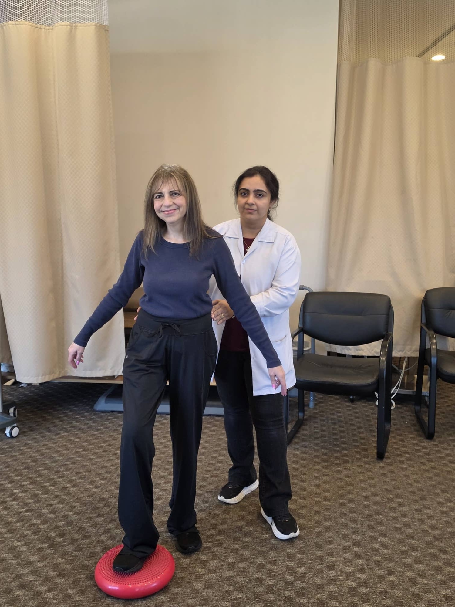 Therapist guiding a patient through balance training at the Massapequa clinic